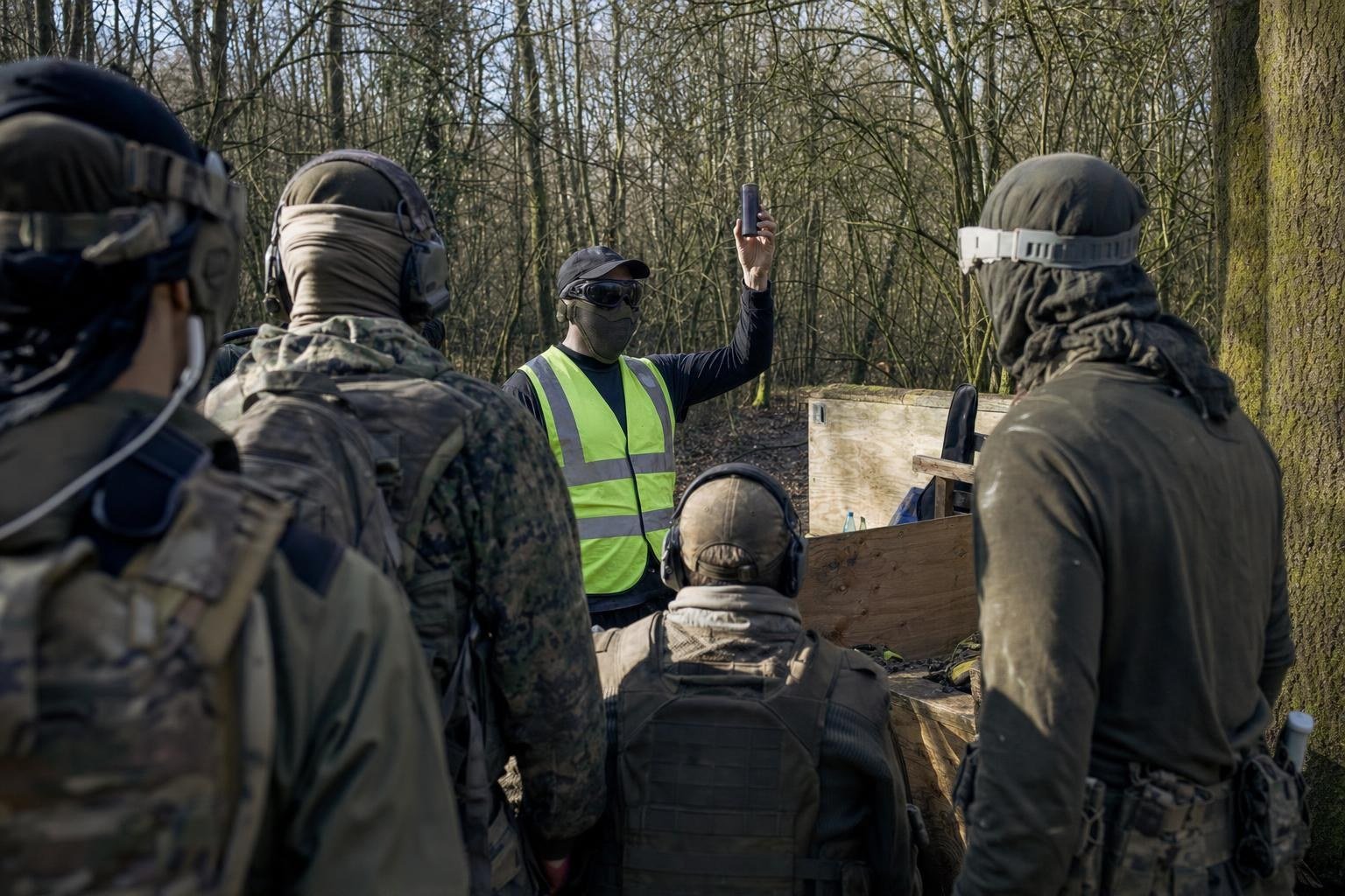 A marshal explaining pyro rules to airsoft players in a safe zone