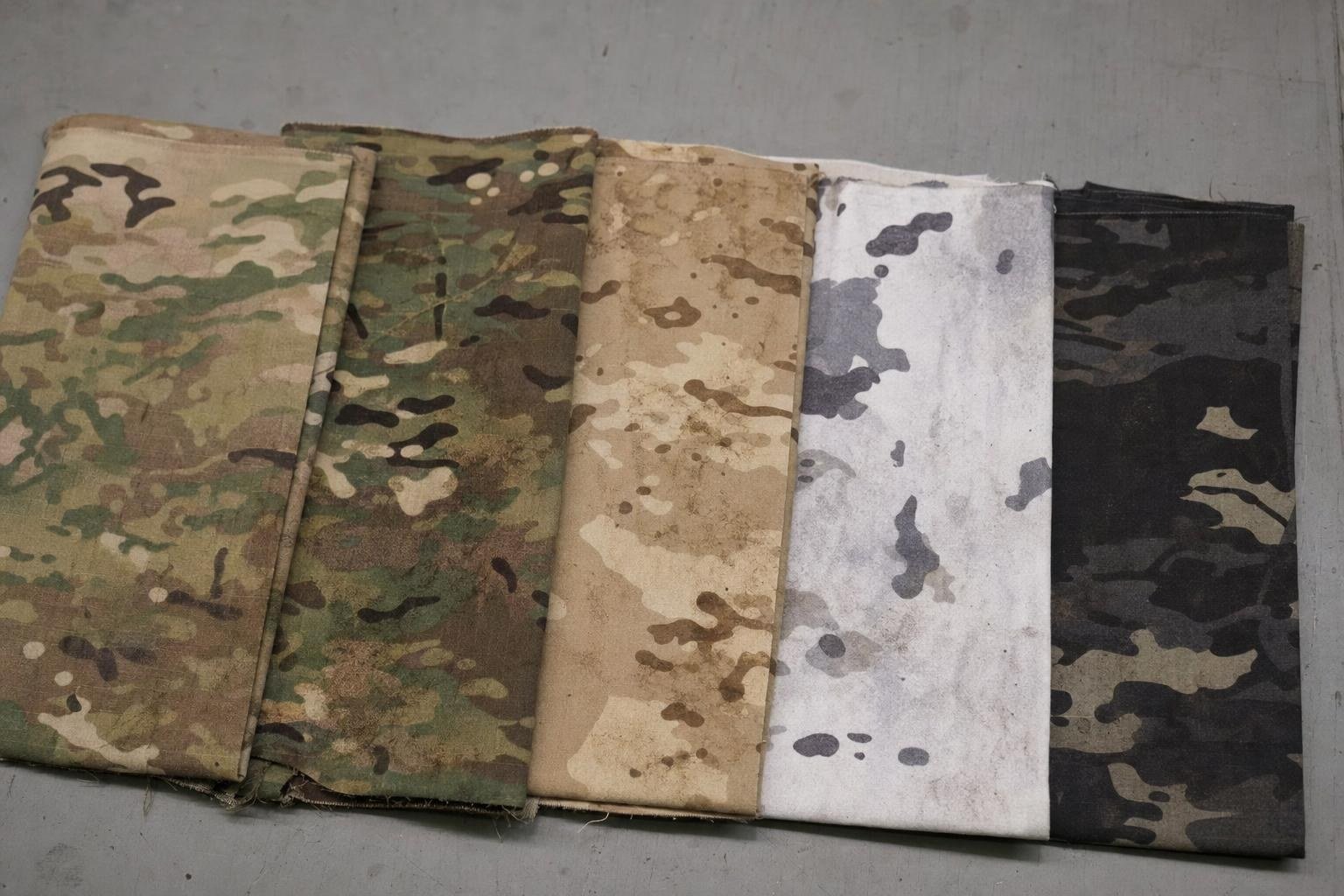 Swatches of MultiCam, MultiCam Tropic, Arid, Alpine and Black