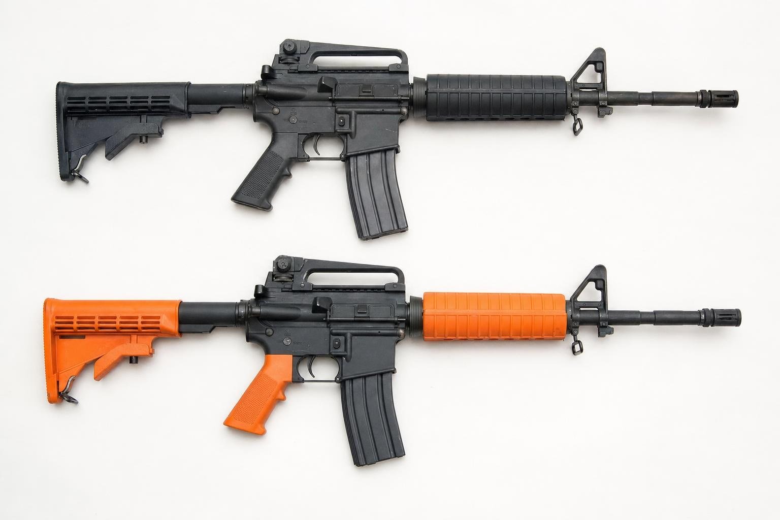 Realistic black airsoft rifle above a two-tone orange airsoft rifle for comparison